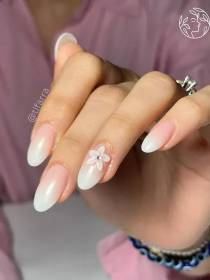 Learn to create subtle 3D art that adds a touch of elegance. This beautiful baby boomer ombre nail is accented with a small, hand-sculpted 3D flower, a technique we cover in our advanced art modules.