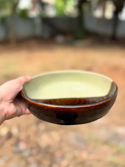 The striking diagonal line on this half-glaze plate separates the earthy tones of our Celadon and the rich darkness of our Tenmoku glaze.