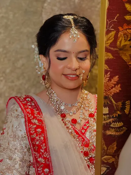 A close-up on the soft, shimmering eye makeup and the flawless skin that defines this regal bridal look.