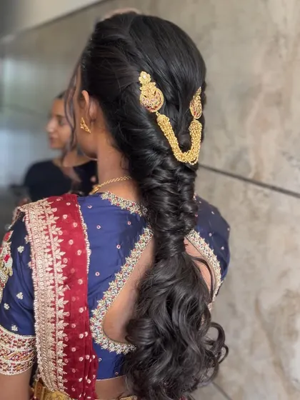 A side view of the modern fishtail braid, showing how traditional gold accessories can be used in a contemporary way.