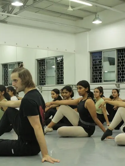 A floor work exercise during a dance intensive. These sessions build strength, flexibility, and control from the ground up.