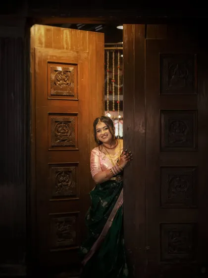 A playful and happy bride peeking from behind a door during her engagement. Her smile is infectious, and the moment is full of charm.