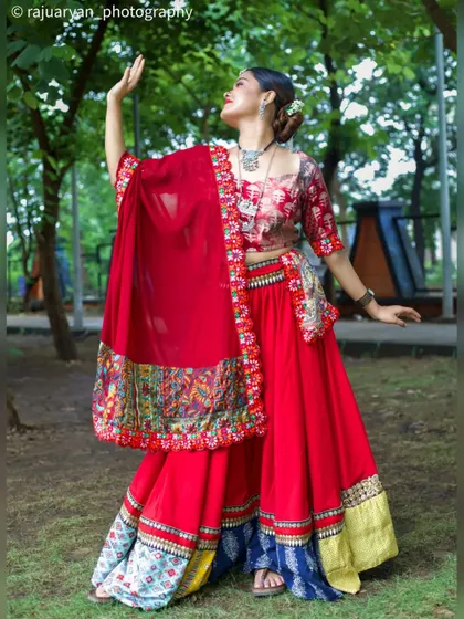 Capturing the vibrant energy of ethnic fashion in an outdoor setting. This dynamic shot of a model in a red chaniya choli shows how I use movement and natural environments to create lively and expressive portraits.