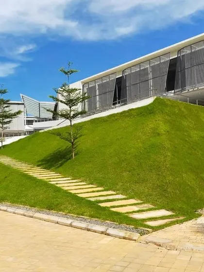 At the DRL Leadership Academy, we created large green mounds that tuck in classrooms at the ground floor. These berms provide natural insulation and also become informal seating spaces for students.
