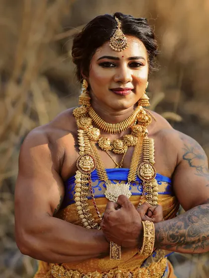 A full-frontal pose, combining the commanding presence of a bodybuilder with the intricate beauty of traditional Indian culture.