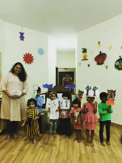 Proudly showing off their creations! After a musical story, these little ones hold up the art they made. Every workshop includes a take-home craft related to the theme.