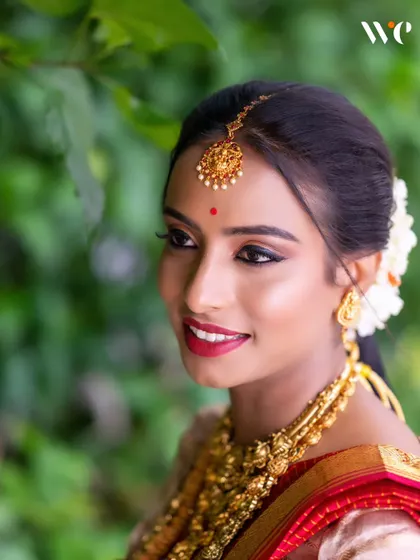 A stunning bridal portrait. We use natural light to highlight the bride's features, her intricate gold jewellery, and her beautiful traditional attire.
