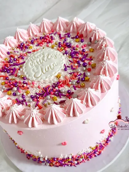 Sprinkles make everything better! A simple but fun pink cake covered in a custom sprinkle mix and meringue kisses.