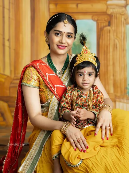A beautiful family portrait celebrating tradition. This mother and her two children, all dressed as Krishna, create a unique and memorable festive photo.