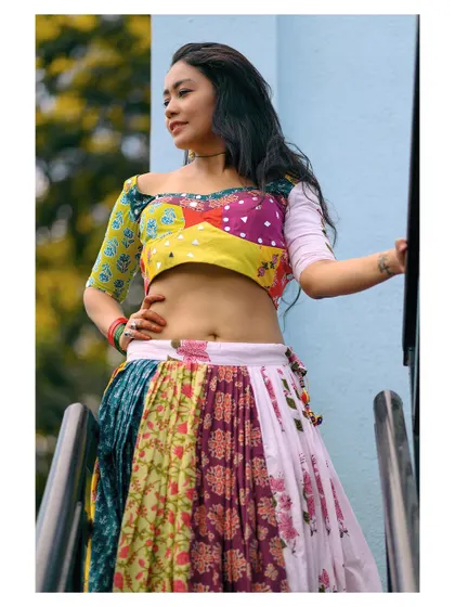 A vibrant and colorful portrait in a patchwork folk costume. The image is full of life and celebrates traditional culture.