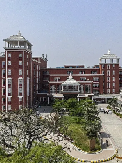 A closer view of the Sharda Care Healthcity building, highlighting the blend of traditional architectural motifs with modern construction. The design creates an impression of an established, trustworthy institution.