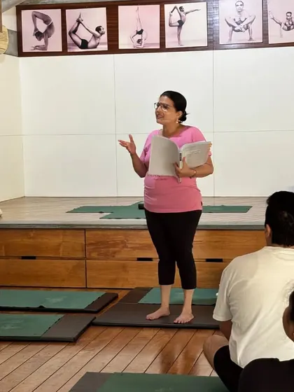 Learning is a conversation. Here, I am speaking to the class, holding my notes, ensuring the sequence is precise and tailored to their needs. Every student feels seen and heard.
