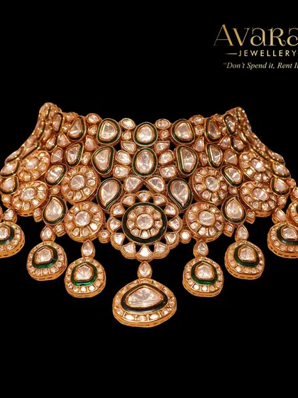 This stunning polki choker is a masterpiece of traditional craftsmanship. The intricate design and high-quality stones make it a perfect centerpiece for any bride's jewellery collection.