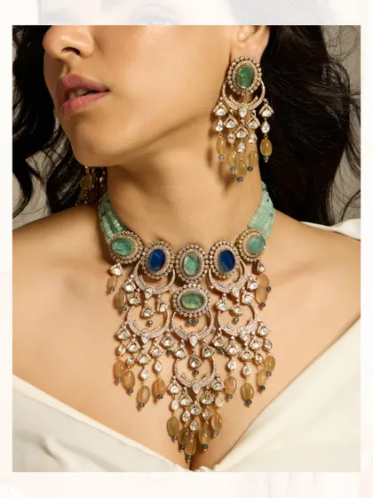 A unique and artistic necklace featuring a cascade of polki-set hoops and colorful stones.