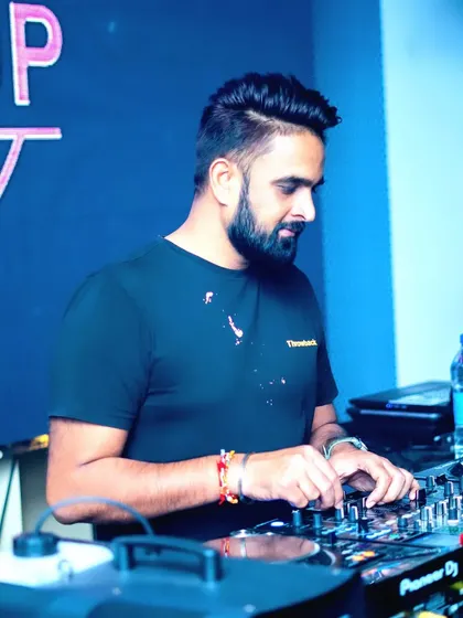 A candid shot of me at the console during a club night. I am always focused on the technical details to ensure the sound is perfect.