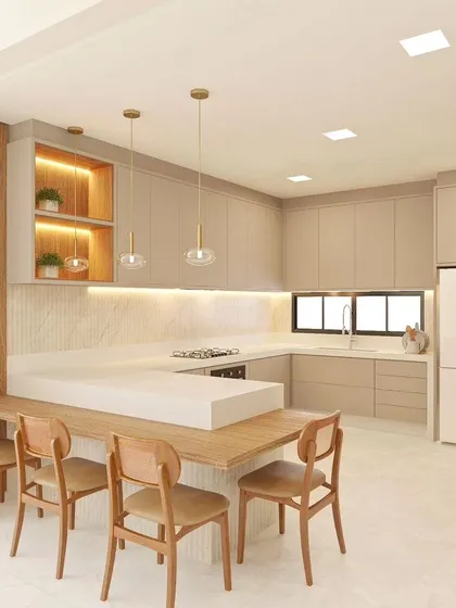 This kitchen design integrates the dining table with the island, creating a multifunctional space for cooking and family meals.