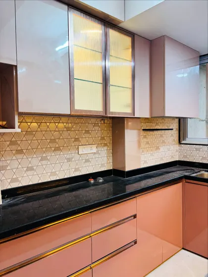 The fluted glass on the upper cabinets adds a touch of sophistication and partially conceals the contents for a cleaner look.
