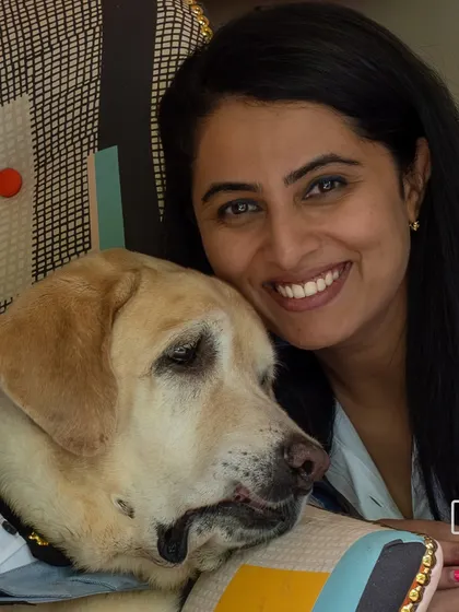 A beautiful portrait of a woman and her senior labrador, capturing the deep bond and affection between them.