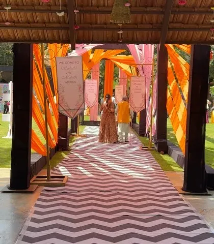 Guests walk through the colorful carnival entrance, setting the tone for a fun and energetic celebration.