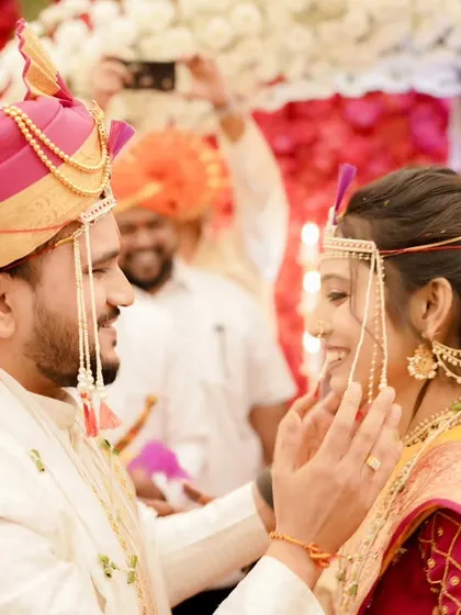 A tender moment between the couple. The bride's soft makeup and traditional jewelry create a look of pure elegance.