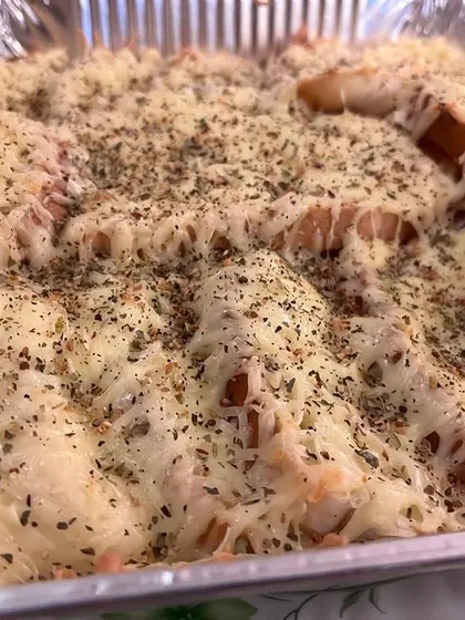 This cheesy garlic bread is loaded with herbs and a generous layer of melted cheese, making it an ultimate comfort food snack.