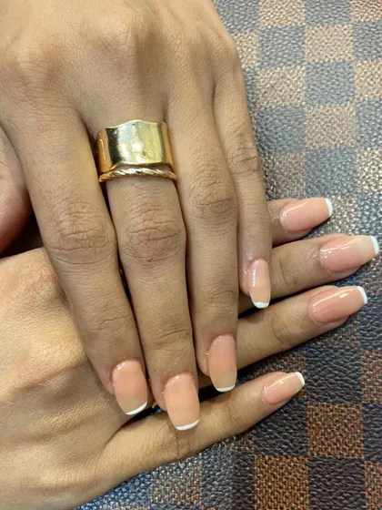 Another angle showcasing these perfectly glossy and timeless French tips. This look is ready for any occasion, from a business meeting to a wedding.