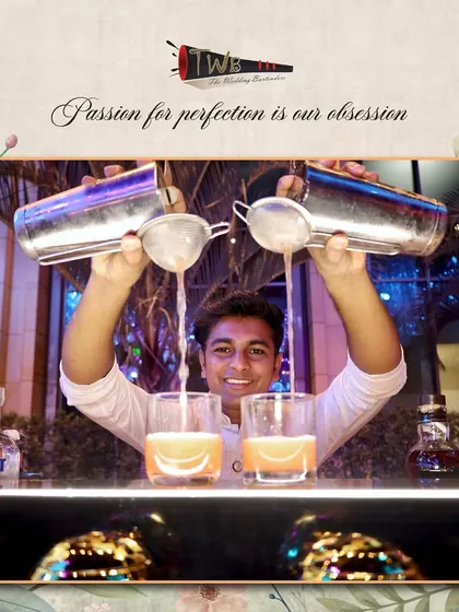 The dual pour. One of our skilled bartenders expertly pours from two shakers at once, a display of skill and efficiency that keeps the drinks flowing at a busy Sangeet.