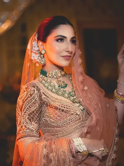 The same bride, exuding warmth and elegance. The styling focuses on a soft, romantic color palette perfect for a day function.