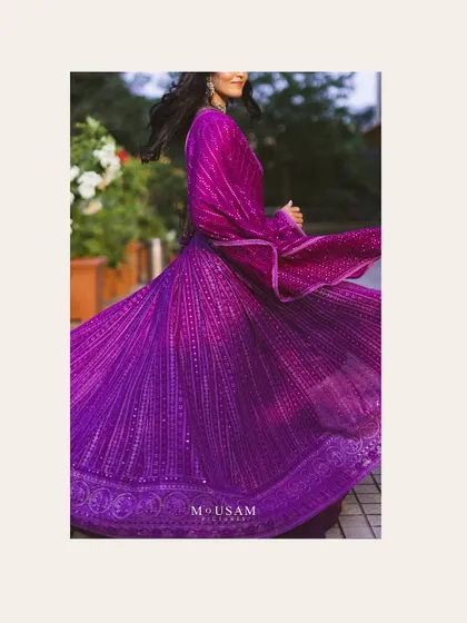 The beautiful movement of the bride's purple lehenga during her Mehendi ceremony. This action shot captures the fabric's flow and the vibrant color, adding a dynamic and artistic element to the gallery.