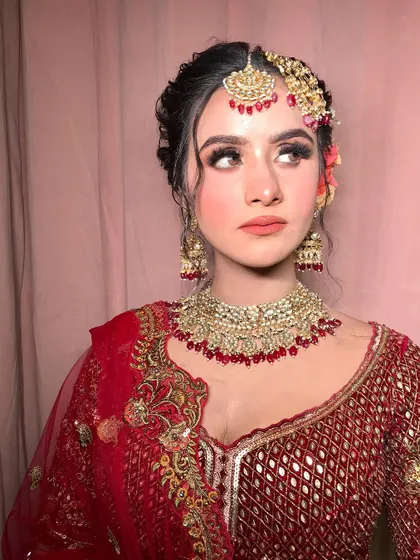 A side profile that gives a great view of the intricate hairstyle and floral accessories.