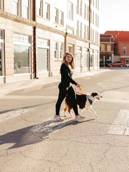 Practicing real-world skills like safely crossing a street is a key part of our training. Here I am with my dog Floki demonstrating good leash manners in an urban setting.