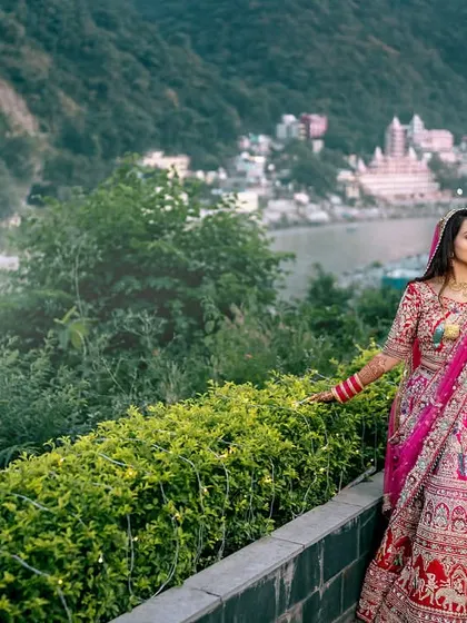 A full-length portrait of the bride walking along a lamp-lit path by the river. A truly magical destination wedding shot.