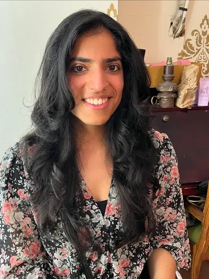 A happy client with her new voluminous hairstyle.