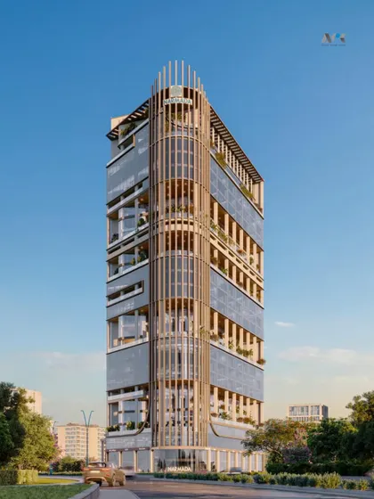 A full view of the Narmada tower's design. The building's form, with its blend of open and closed spaces, is crafted to serve as a hub for showrooms, restaurants, and commercial offices, all while offering stunning views from its corner plot.