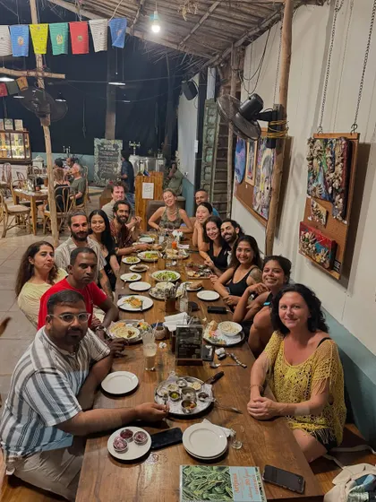 The whole tribe gathered for dinner. The long table is filled with happy faces and empty plates, a testament to the delicious food and warm company.