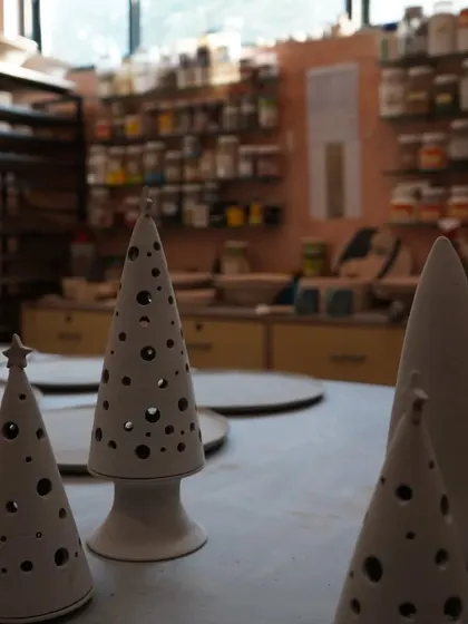 A peek into the enchanting world behind the scenes. This is where the magic happens, with pieces waiting to be glazed and fired.