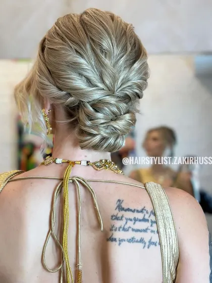 This textured updo was created for an international bride, showcasing how I adapt my techniques for different hair types, including blonde hair. The style features interwoven sections and a soft, romantic finish suitable for a wedding ceremony or reception.