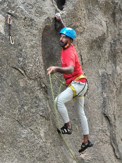A climber maintains control and focus while navigating a route at Ramanagara.