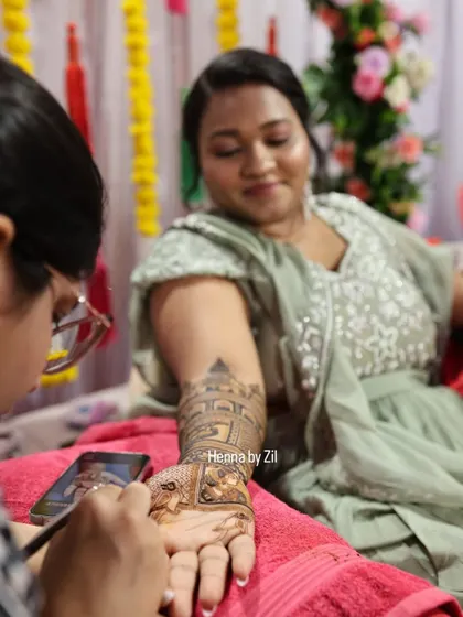A candid shot of me applying a detailed design for a member of the bridal party.