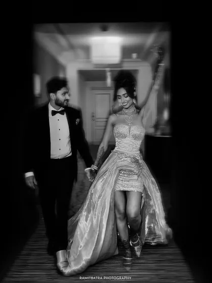 Another take on the corridor walk, this time with the bride joyfully raising her arm, framed in a dramatic vignette.