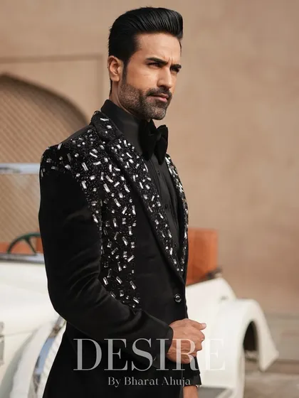 Another angle of the black velvet tuxedo, showcasing the way the silver embroidery catches the light. This is a look designed to shine.