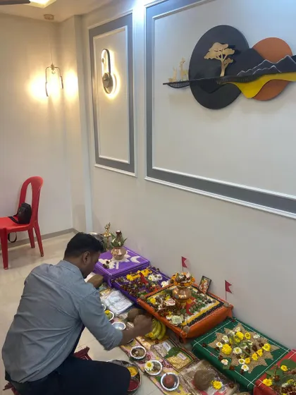 The puja ceremony underway at the Dumbre residence in Kalyan West. The living room wall moulding and art piece add a touch of modern elegance to the space.