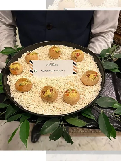Another look at our innovative Mexican Golgappe, presented on a bed of puffed rice. This dish perfectly represents our love for creating unexpected fusion bites.