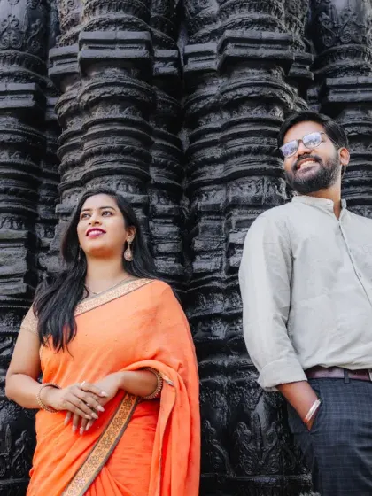 A confident and stylish pose against an ancient-looking temple wall. This pre-wedding shot mixes traditional elements with modern couple portraiture for a unique and striking result.