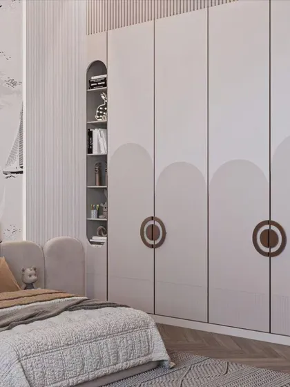 A charming nautical-themed kids' room. The wardrobe features unique circular handles and is flanked by open shelving, while the wallpaper and decor complete the seafaring adventure theme.
