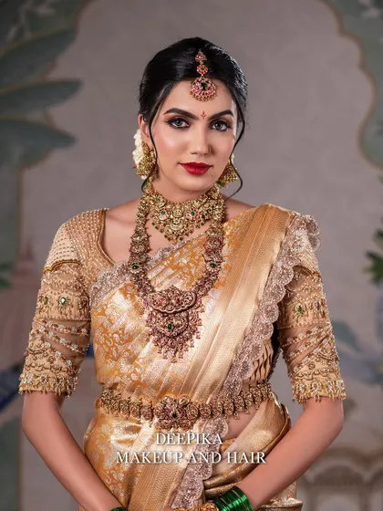 A stunning close-up of the bride's face, focusing on the bold red lip and sharp, defined eyes that are hallmarks of a classic bridal look.