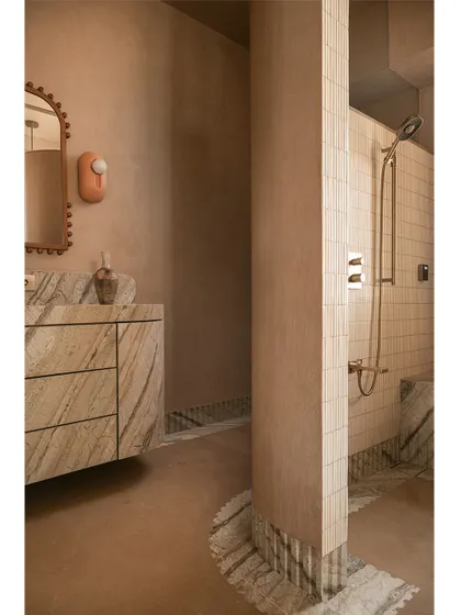 Another angle of the master bathroom, showing the seamless transition from the micro-concrete walls to the tiled shower area.