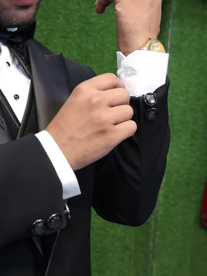 It's all in the details. This photo shows the cuff and buttons of our embellished black tuxedo, highlighting the quality of the finish.