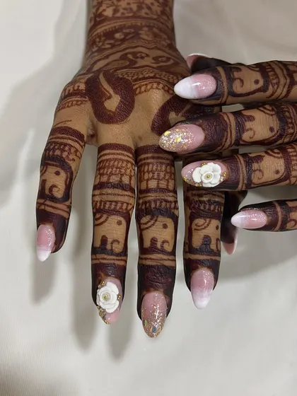 A close-up view of the 3D floral work and glitter accent nail. I pay close attention to every detail to ensure your wedding nails are flawless from every angle.