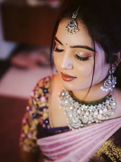 A close-up of Chandana's engagement makeup. The soft, shimmery eyeshadow and neutral lip color create a look that is both modern and timeless.
